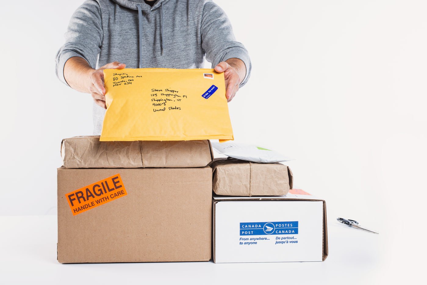 Man holding up packages ready for fulfilment, Amazon account management for UK brands