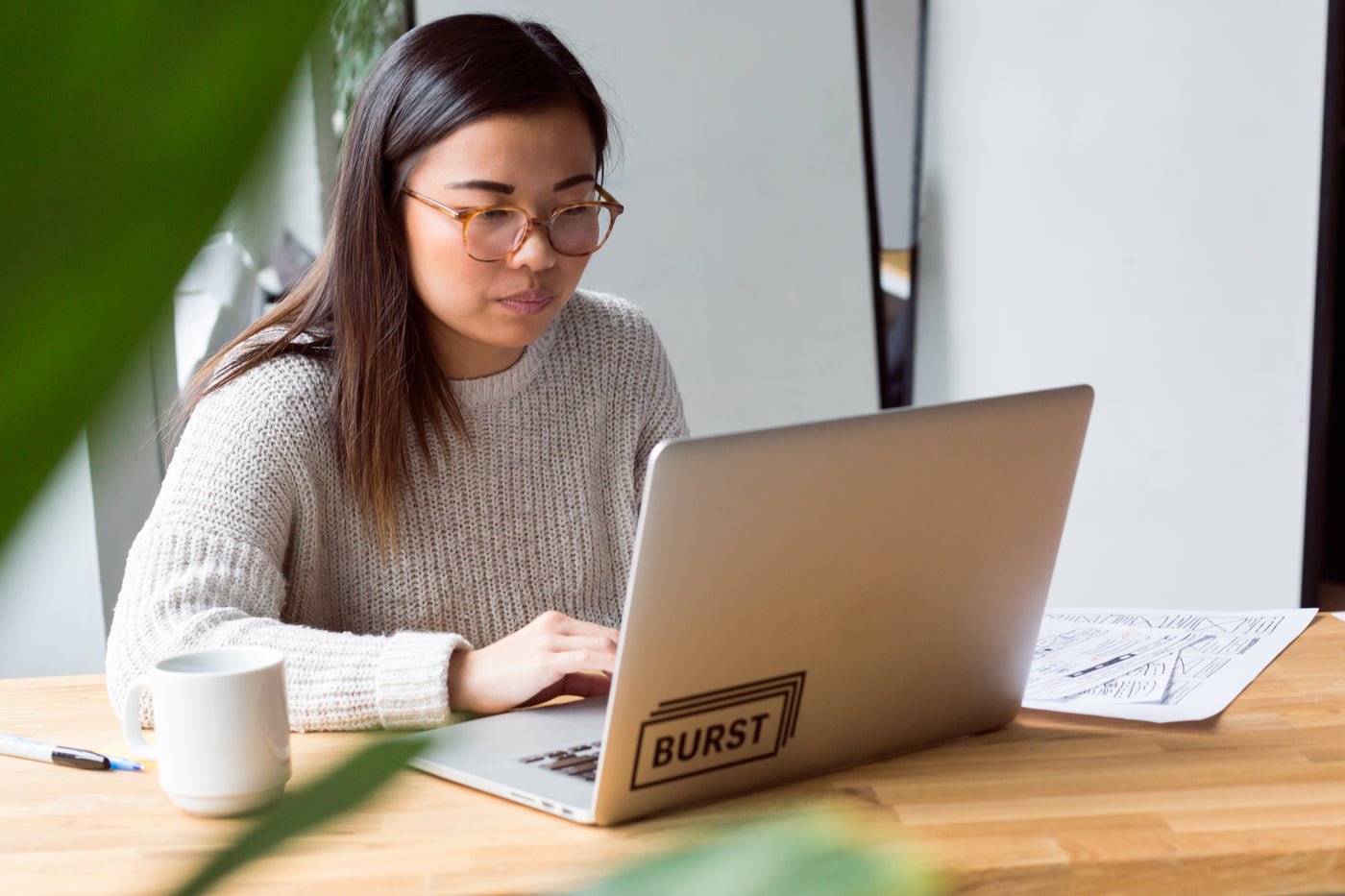 Freelance designer working on a laptop building a website