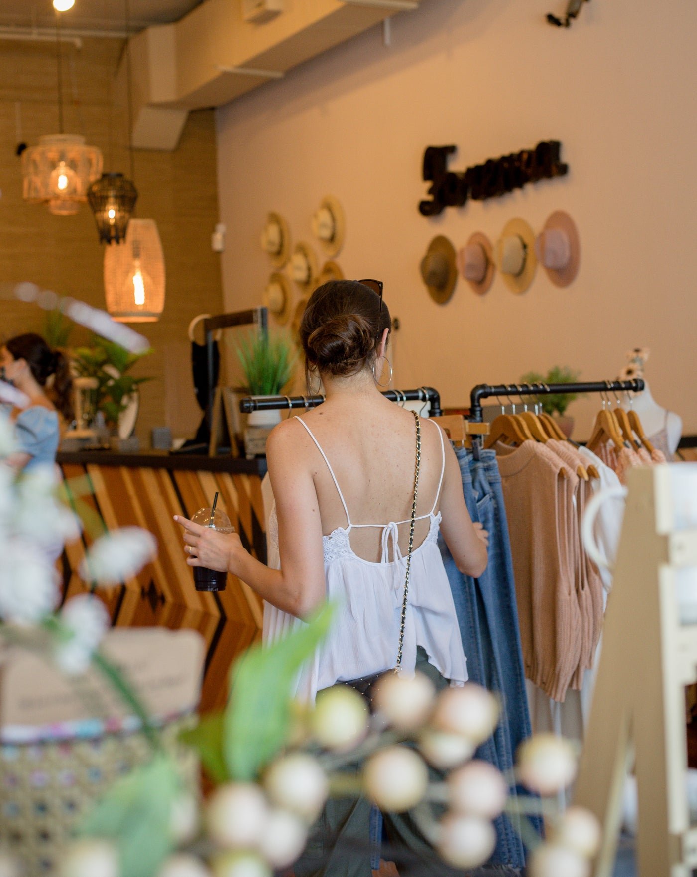 Person browsing clothing racks in a store