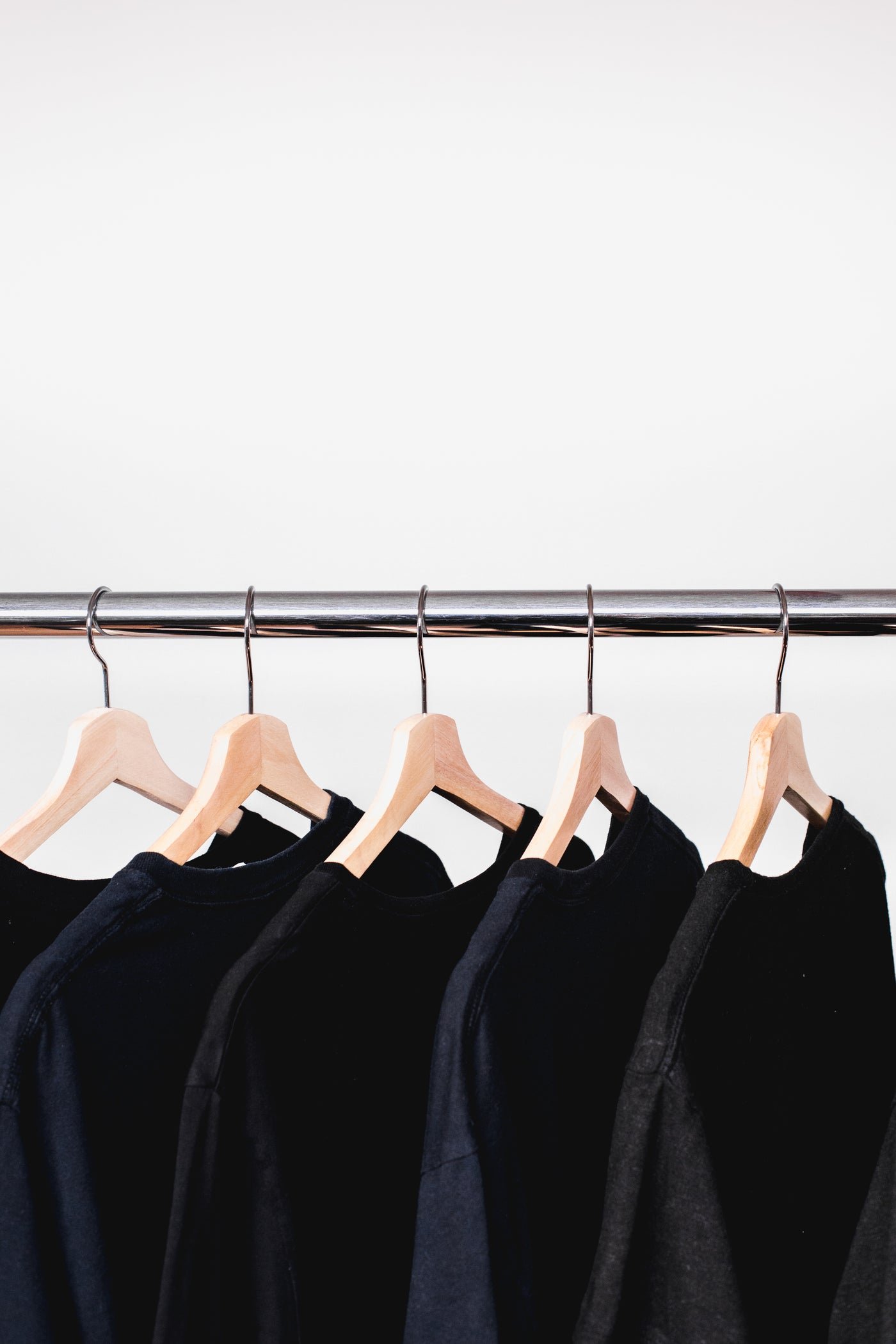 Rail of black sweatshirts in a clothing store