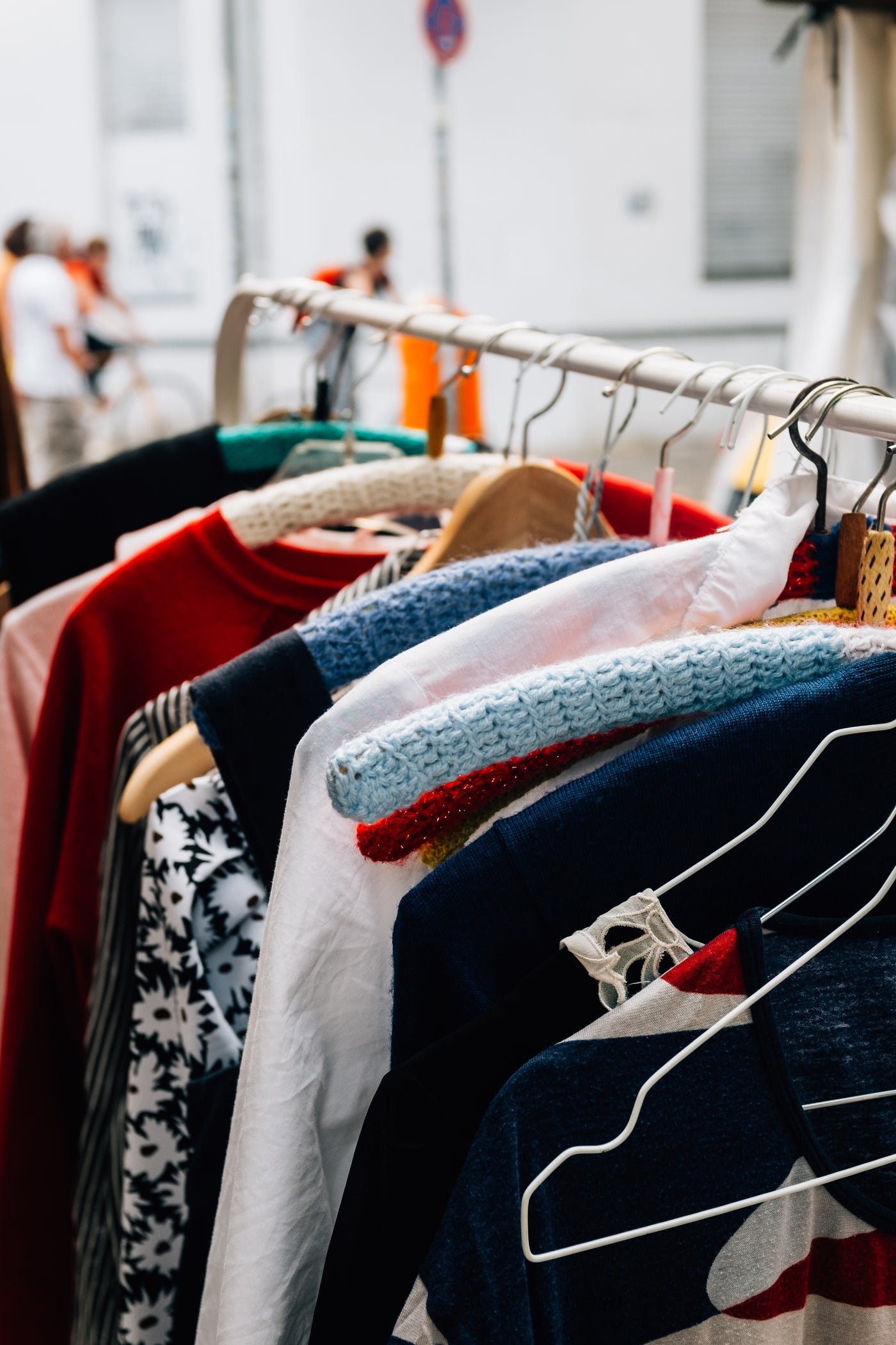 Colourful clothing hanging on a rail, side view